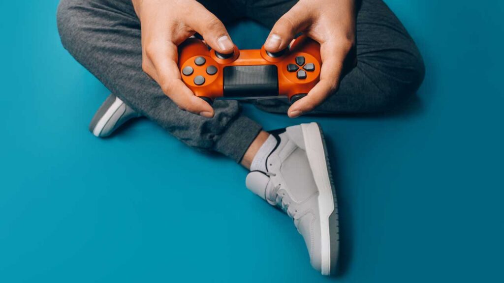 person holding sony playstation controller