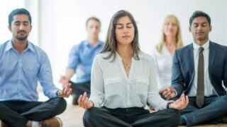 people doing yoga in office