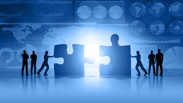 people pushing giant puzzle pieces together