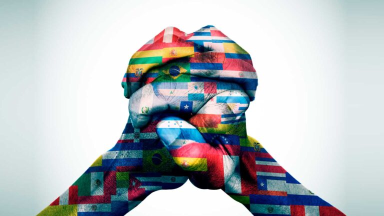 2 hands grasping with an overlay of national flags