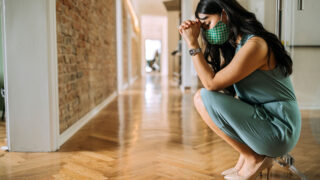 woman praying or looking stressed in hallway