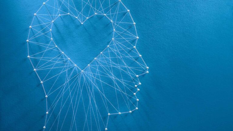 thread art of a human profile with a heart