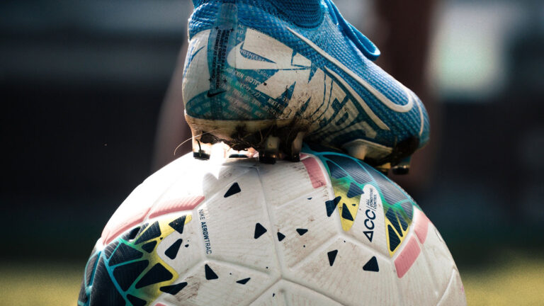 cleated foot on soccer ball