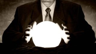 man with hands on glowing orb