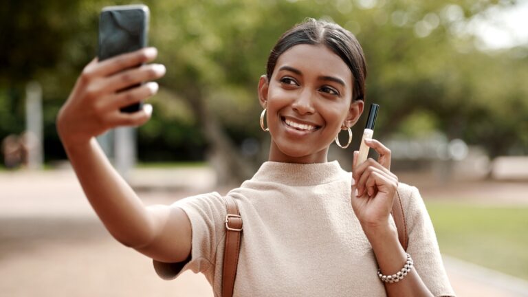 woman taking selfie with cosmentics