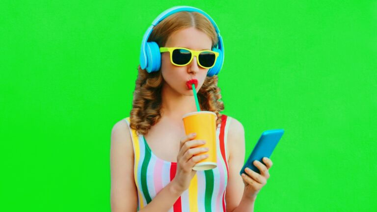 girl with headphones, glasses, phone, drink