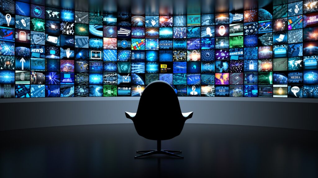 chair in front of hundreds of TVs
