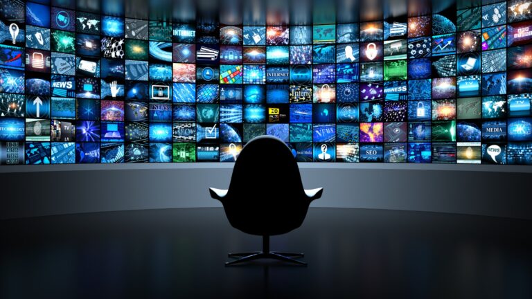 chair in front of hundreds of TVs