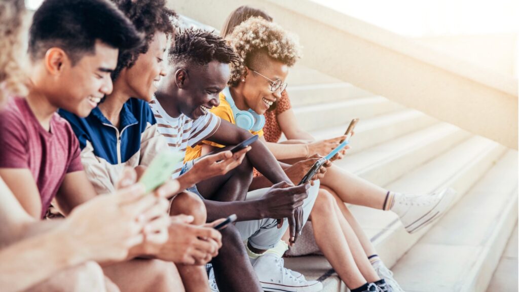 people of color smiling at their phones