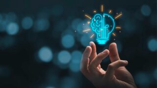 hand-holding-drawing-virtual-lightbulb-with-brain-on-bokeh-background-picture