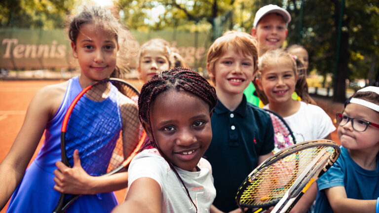 A group photo of several young children from different backgrounds taking a selfie