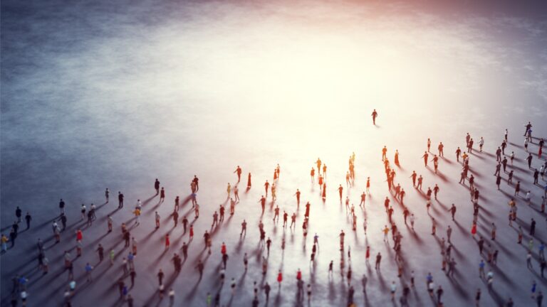 A photo of one person leading hundreds