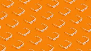 pattern of white rayban looking glasses on an orange background