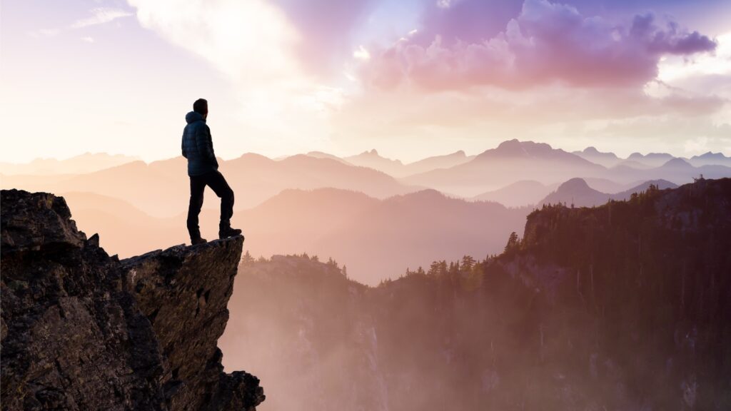 Man Hiker on top of a Mountain Peak