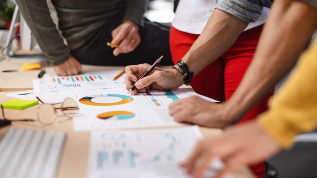 A photo of workers at a B2B agency examining charts and other data