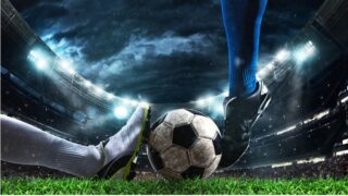 Close up of a football action scene with competing soccer players at the stadium