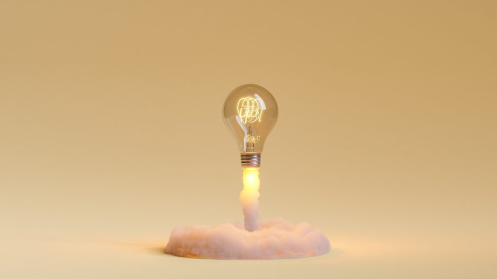 Light bulb rocket taking off stock photo