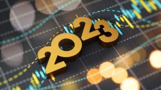 2023 Sitting On Financial Graph Background stock photo..