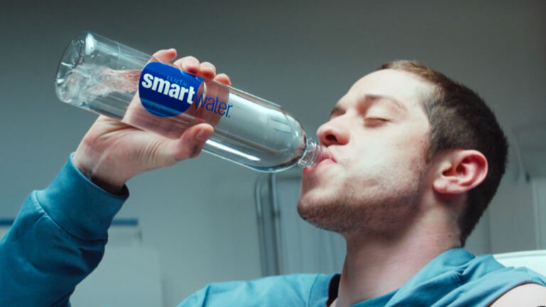 Man drinking from a Smartwater bottle