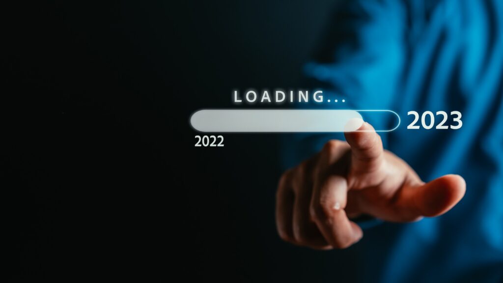 Businessman touching to virtual download bar and loading for New Year and changing year 2022 to 2023