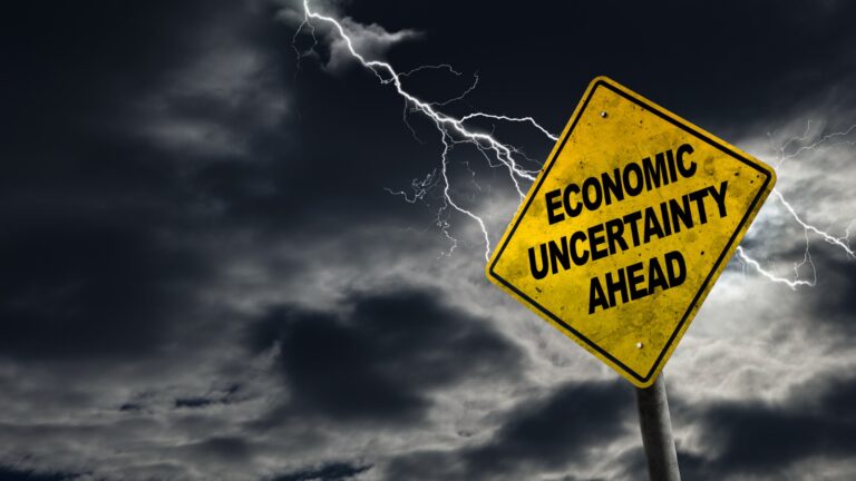 Economic Uncertainty Ahead Sign With Stormy Background stock photo