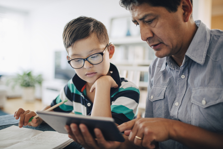 man and child working on child's homework